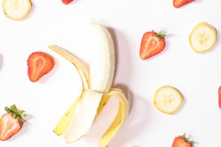 Sliced bananas and strawberries arranged in a pattern | Eating Healthy on a Budget